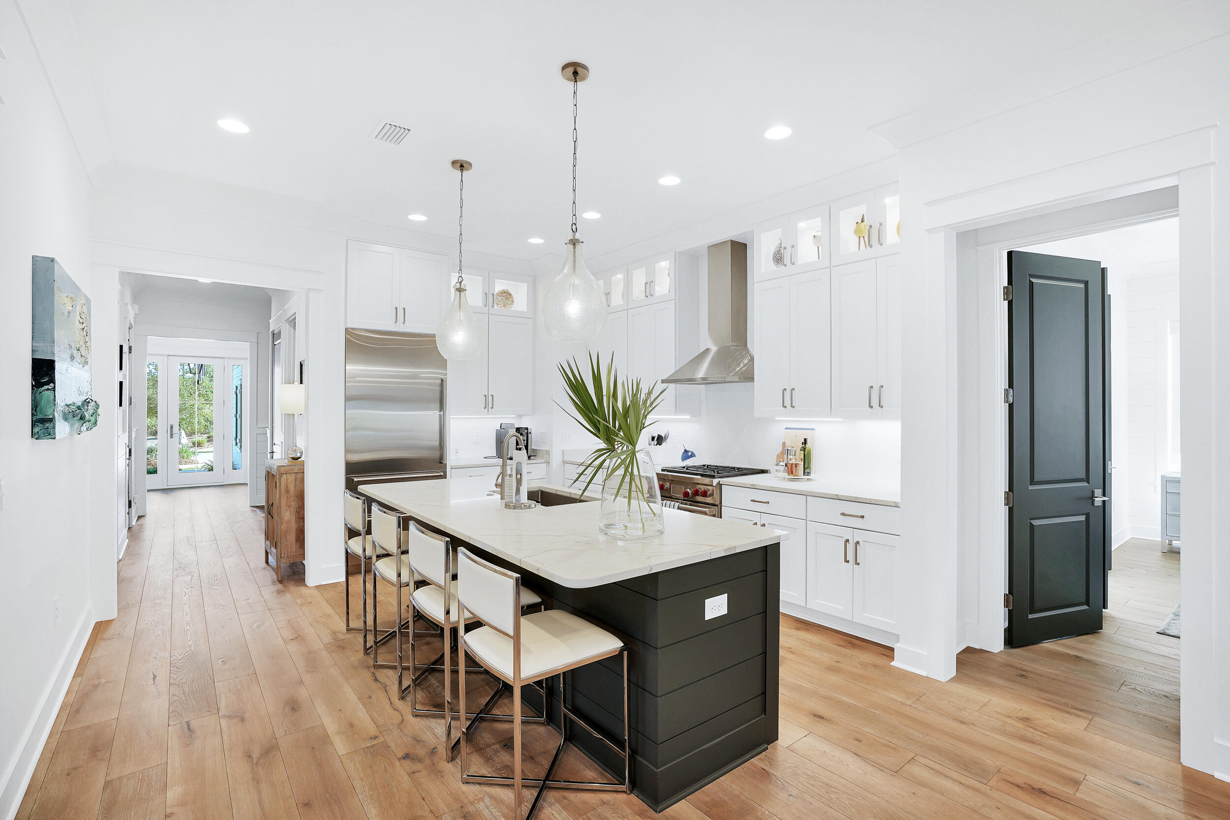129 Firefly Way, Unit LOT 75 Watersound, FL 32461 - Photo 48 of 56 a view of a kitchen with kitchen island stainless steel appliances wooden floor cabinets