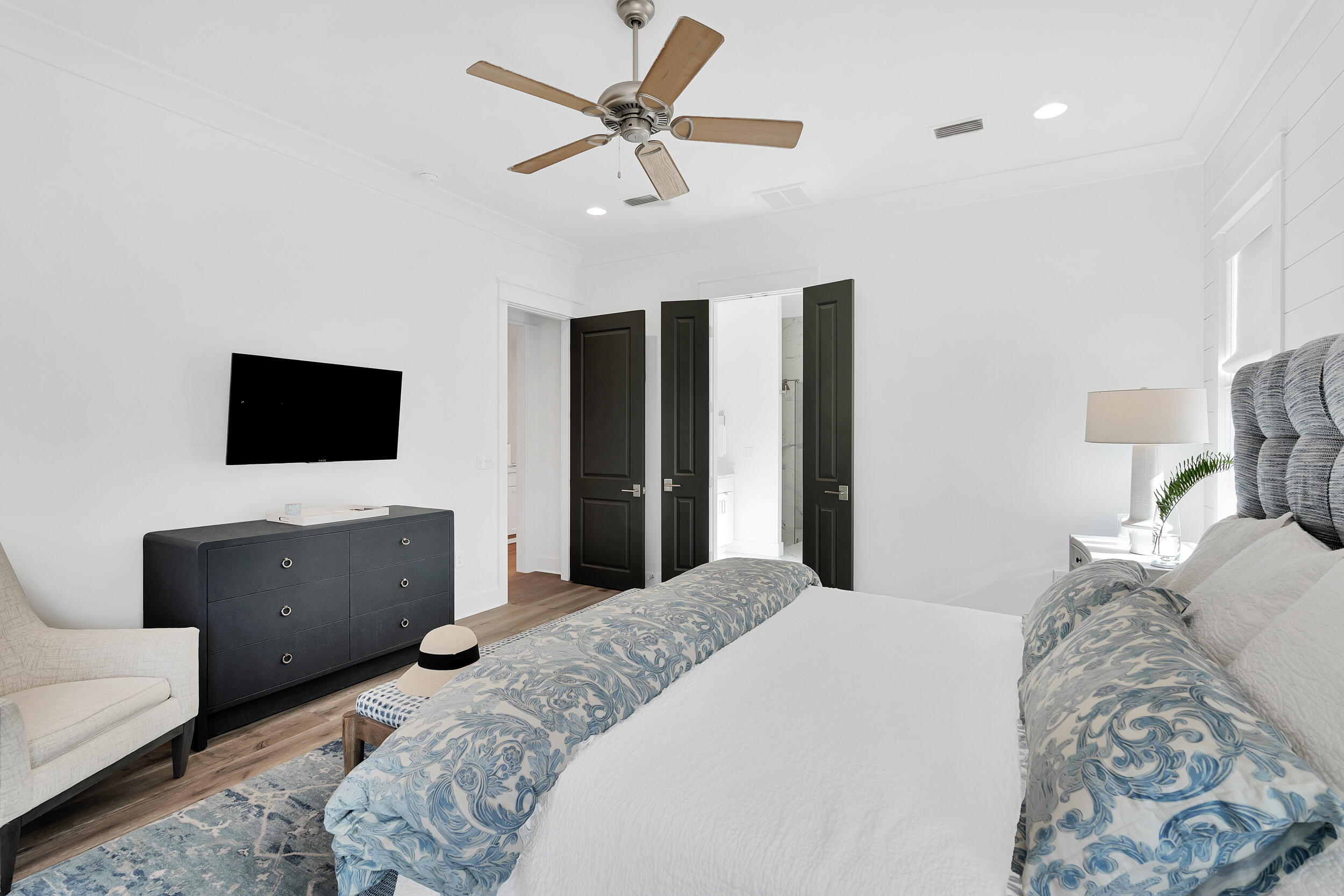 129 Firefly Way, Unit LOT 75 Watersound, FL 32461 - Photo 9 of 56 a bedroom with a bed flat screen tv and a couch