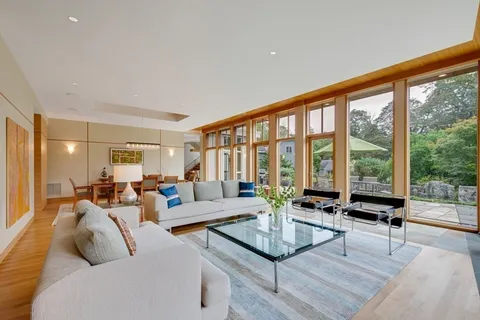 a living room with furniture and large windows