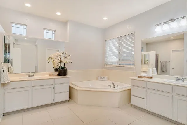 a bathroom with a bathtub sink and mirror