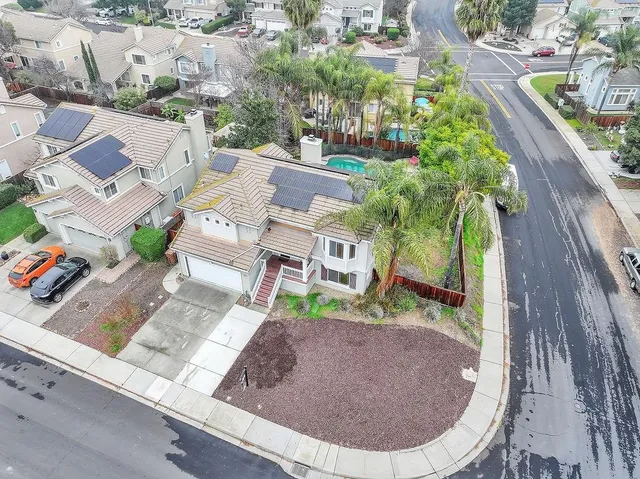 an aerial view of residential houses with outdoor space