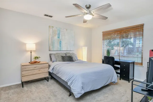 a bedroom with a bed and a table with chair