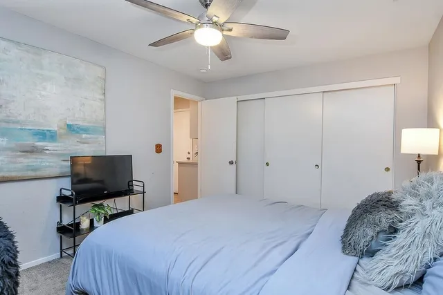 a bedroom with a bed and a flat screen tv