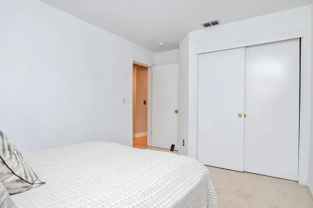 a bedroom with a bed and a shower