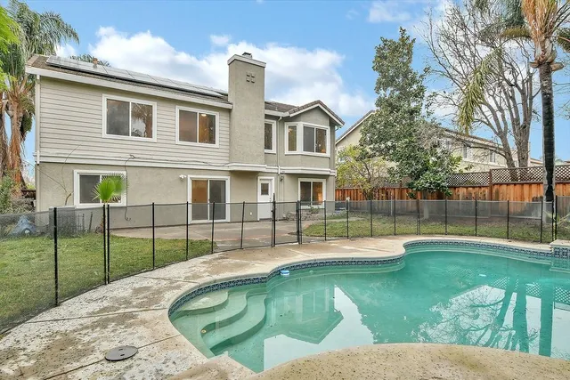 a view of a house with a backyard