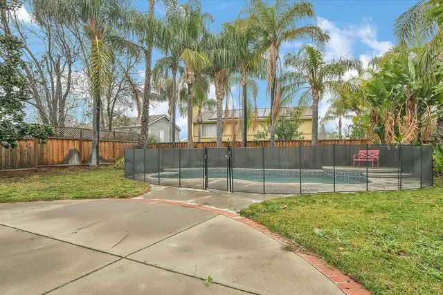 a view of backyard with wooden fence