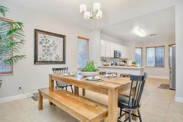 a dining room with furniture and a kitchen view