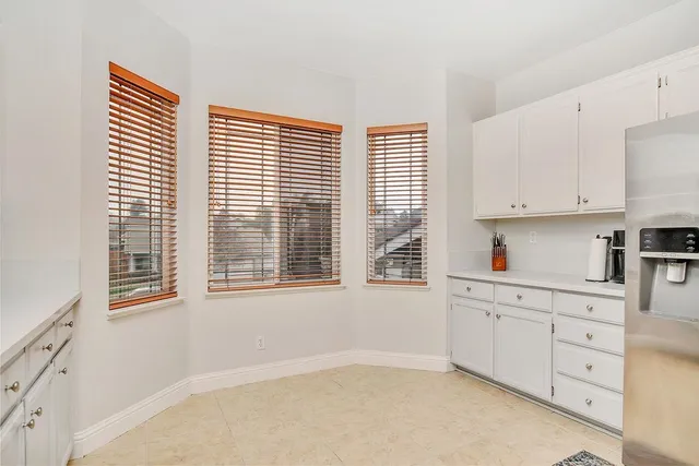 a kitchen with stainless steel appliances cabinets and a window