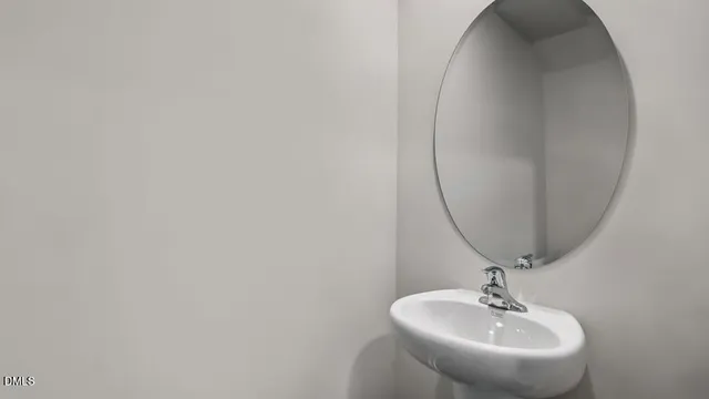 a bathroom with a sink and mirror