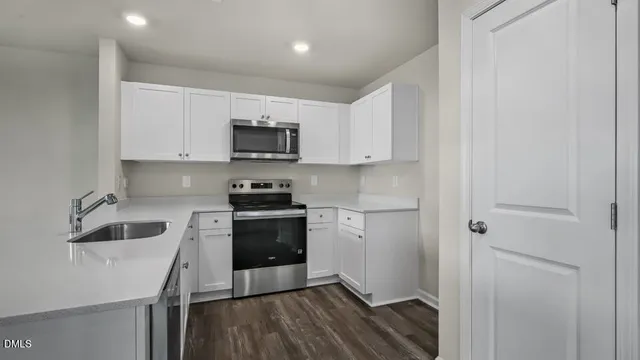 a kitchen with a sink and steel appliances