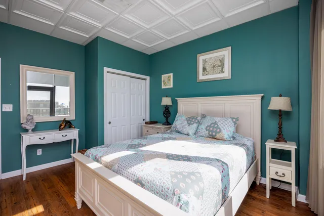 a bedroom with a bed and a large window