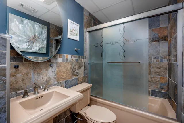 a bathroom with a sink toilet and shower