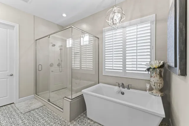 a bedroom with a bed a mirror on dresser and a window