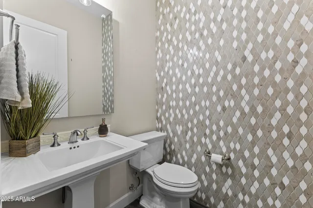 a living room with patio furniture and a garden