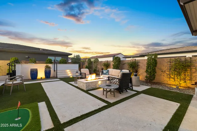 a view of a big house with a big yard and potted plants