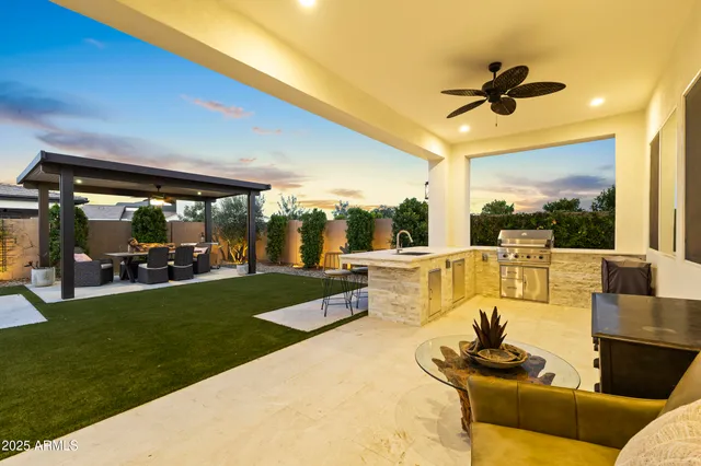 an aerial view of a city with lots of residential buildings and mountain view in back