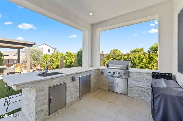 an aerial view of a city with lots of residential buildings and ocean view in back