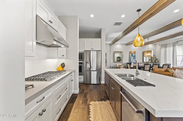a kitchen with stainless steel appliances granite countertop a sink stove and cabinets