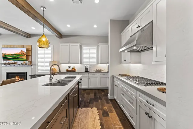a kitchen with a stove a refrigerator and a sink