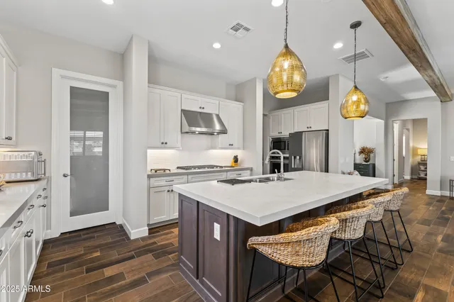 a kitchen with a sink appliances and cabinets