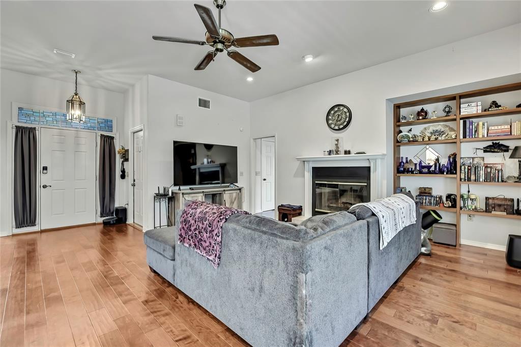 83 Greentree Street Homosassa, FL 34446 - Photo 16 of 49 a living room with furniture a flat screen tv and a fireplace