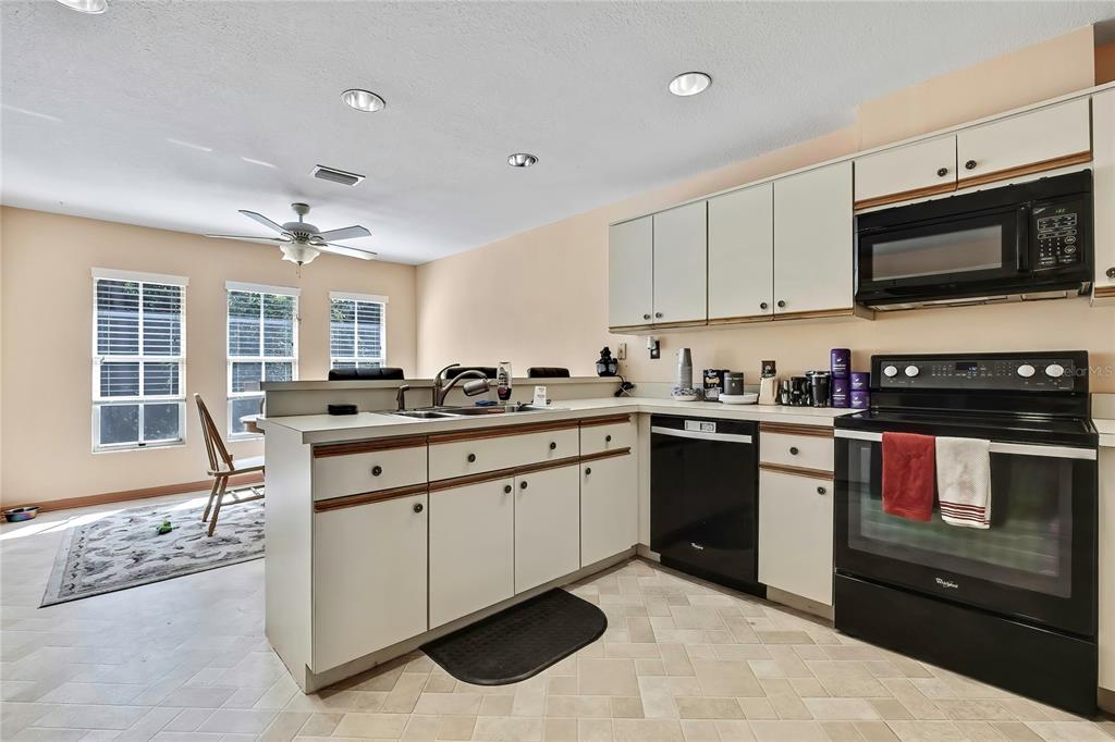 83 Greentree Street Homosassa, FL 34446 - Photo 20 of 49 a kitchen with granite countertop a stove sink and microwave