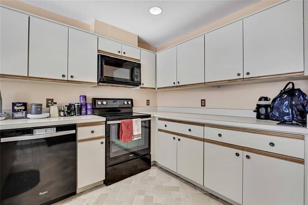 83 Greentree Street Homosassa, FL 34446 - Photo 22 of 49 a kitchen with stainless steel appliances granite countertop white cabinets sink and a stove