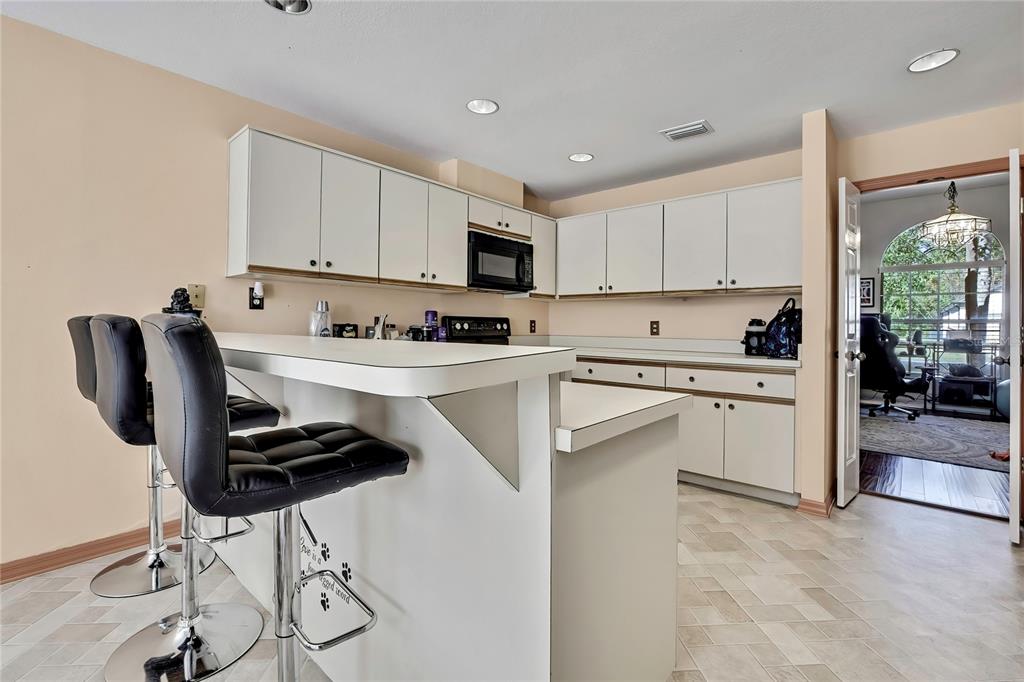 83 Greentree Street Homosassa, FL 34446 - Photo 23 of 49 a kitchen with a sink a stove and cabinets