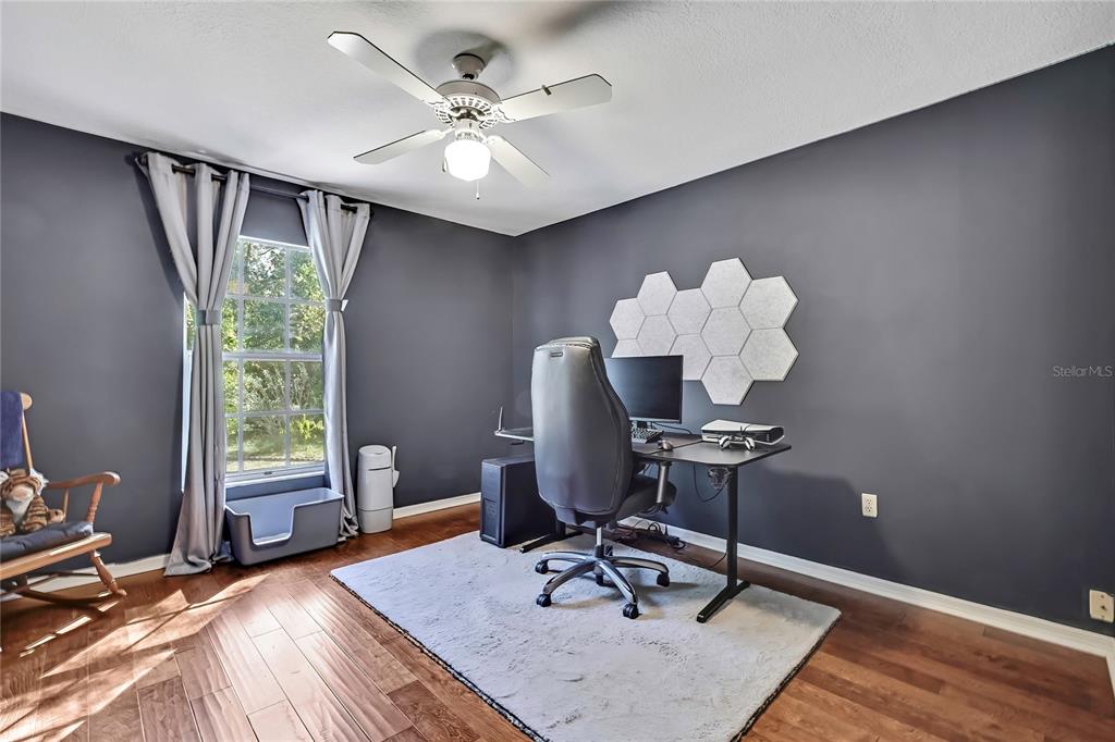 83 Greentree Street Homosassa, FL 34446 - Photo 32 of 49 a dining room with wooden floor and a chandelier