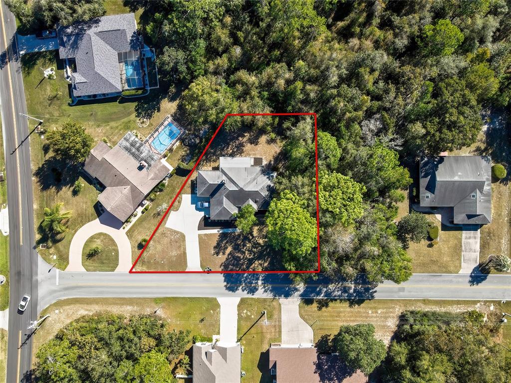 83 Greentree Street Homosassa, FL 34446 - Photo 49 of 49 an aerial view of a house with a yard and garden