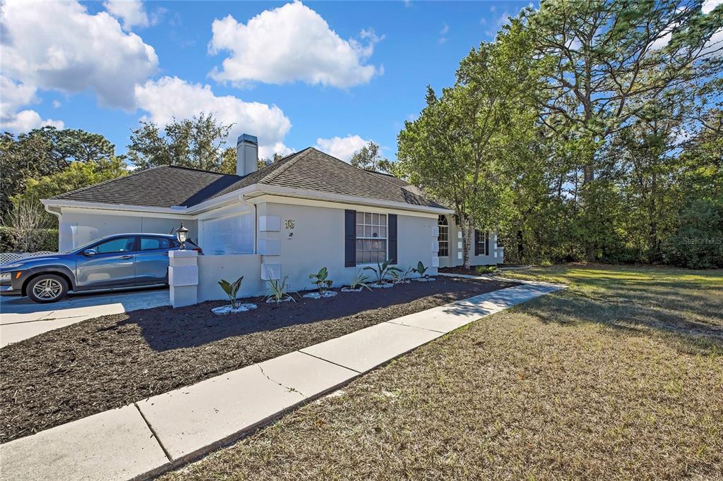 83 Greentree Street Homosassa, FL 34446 - Photo 5 of 49 a front view of a house with a yard