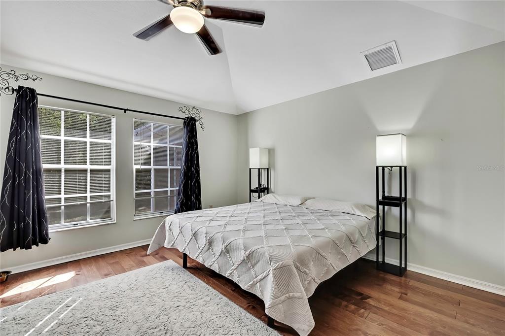 83 Greentree Street Homosassa, FL 34446 - Photo 9 of 49 a bedroom with a large bed and a large window