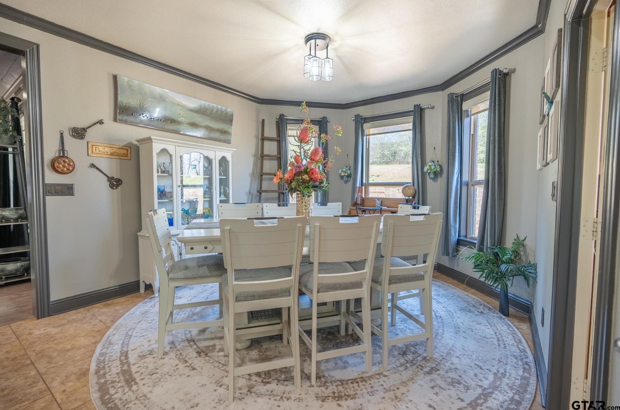 13307 Dustin Road Troup, TX 75789 - Photo 16 of 38 a dining room with furniture a chandelier and window
