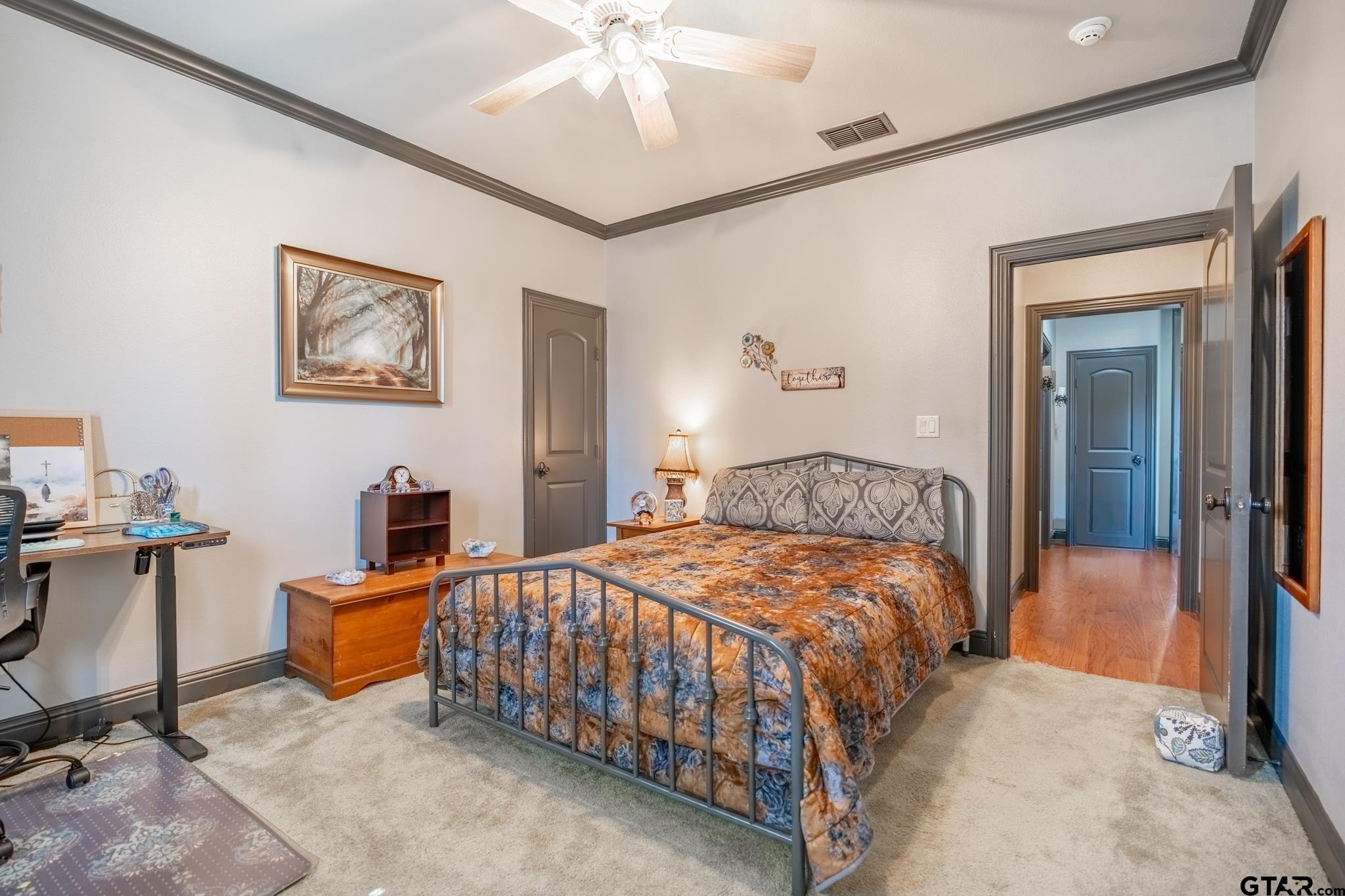 13307 Dustin Road Troup, TX 75789 - Photo 21 of 38 a bedroom with a bed and a chandelier