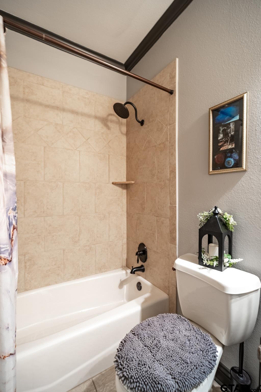 13307 Dustin Road Troup, TX 75789 - Photo 23 of 38 a bath tub sitting next to a white toilet and a shower