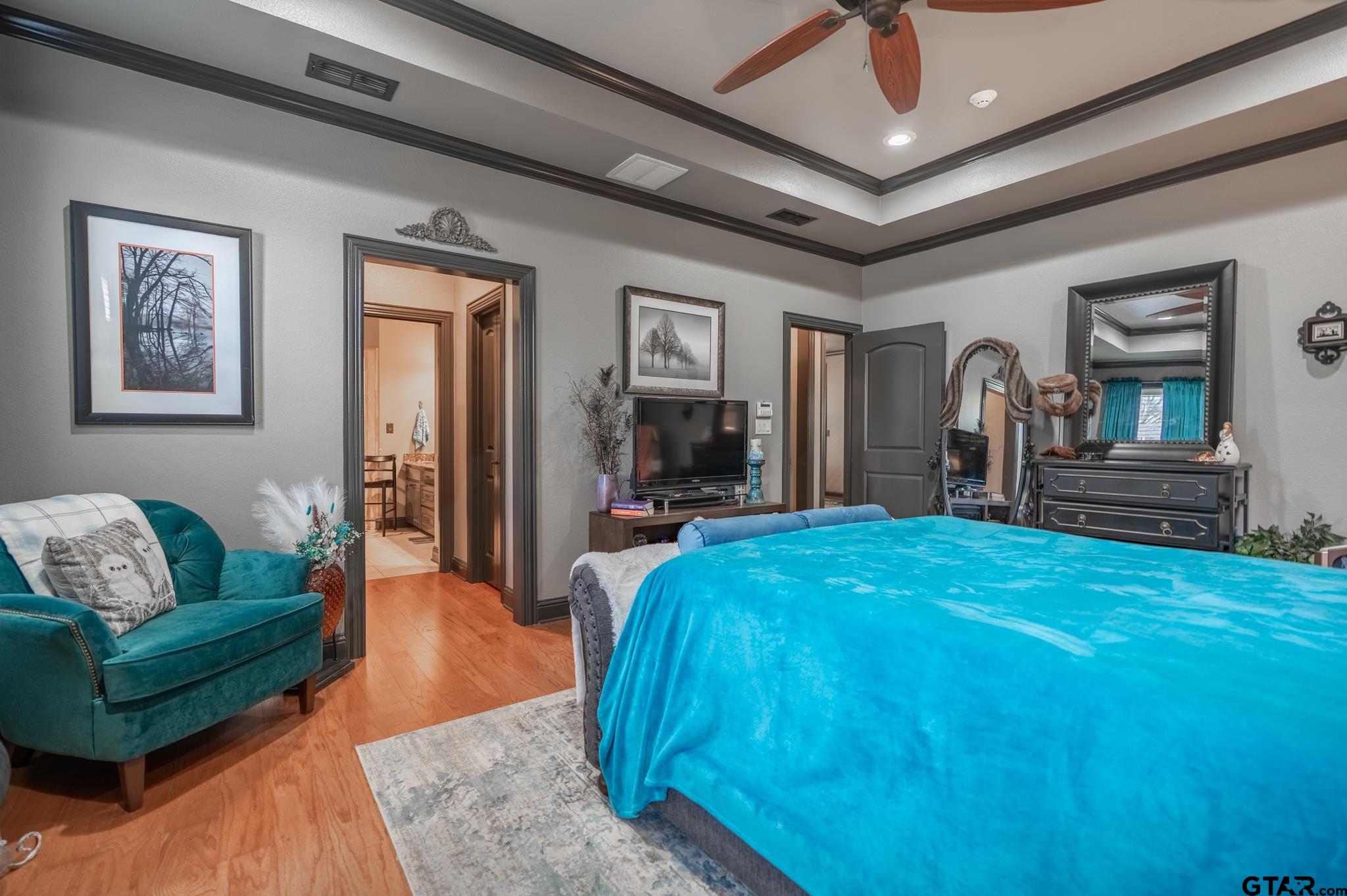 13307 Dustin Road Troup, TX 75789 - Photo 25 of 38 a spacious bedroom with a bed a couch and dresser