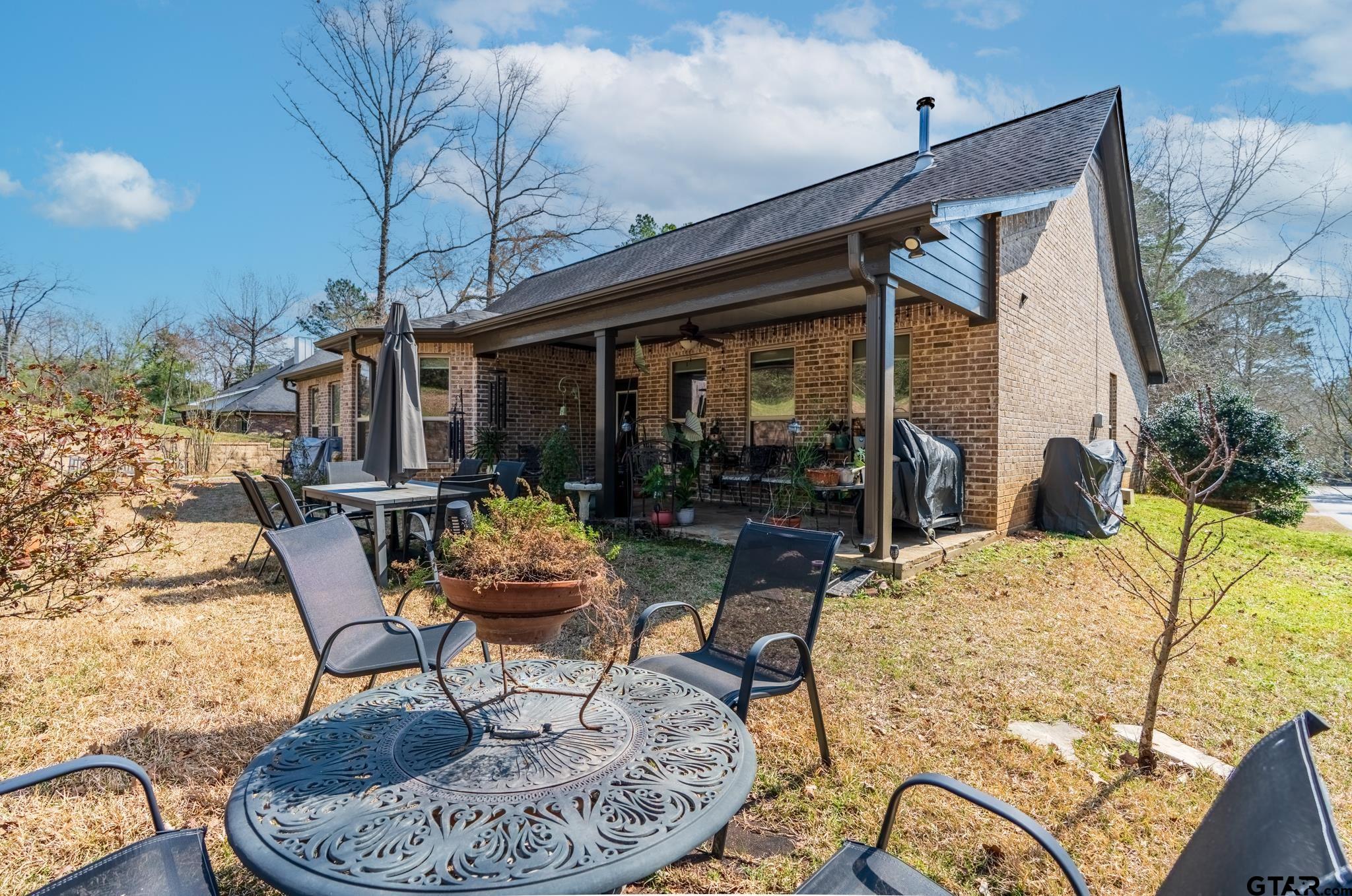 13307 Dustin Road Troup, TX 75789 - Photo 30 of 38 a patio with a table and chairs