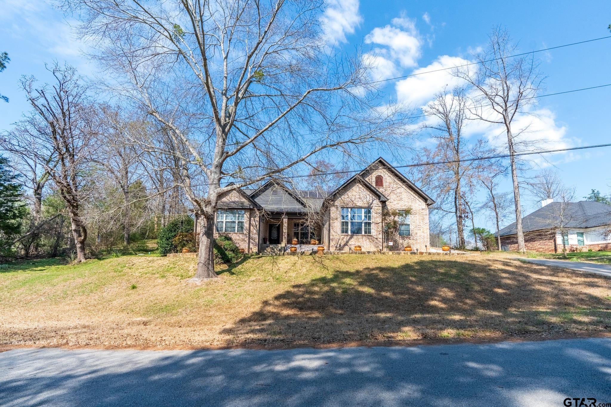 13307 Dustin Road Troup, TX 75789 - Photo 4 of 38 a front view of a house with a yard