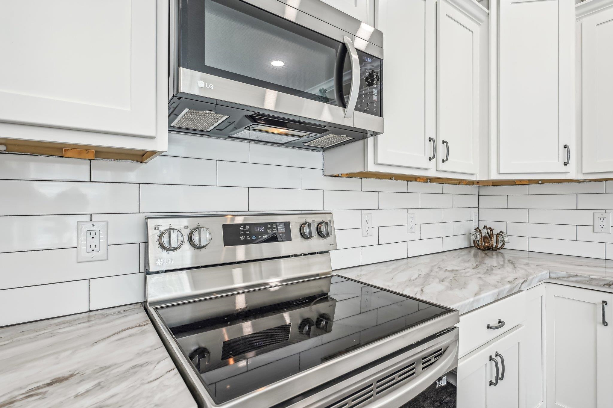 4954 A1A South St. Augustine, FL 32080 - Photo 16 of 42 a kitchen with granite countertop a stove and a sink