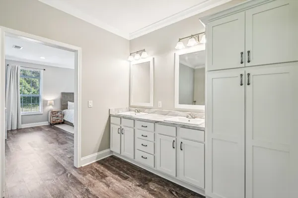 a spacious bathroom with a granite countertop sink and a mirror