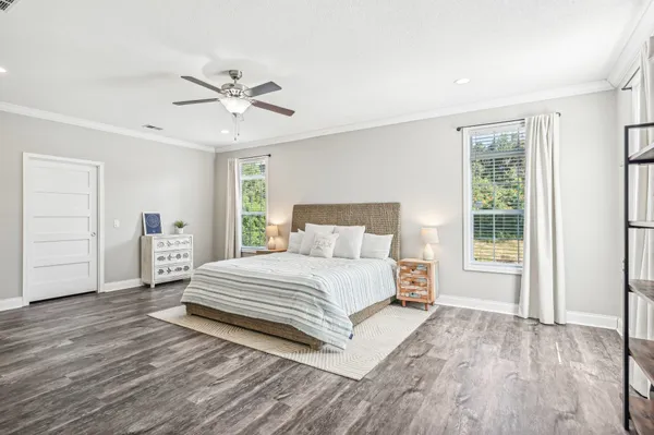 a spacious bedroom with a bed and a window