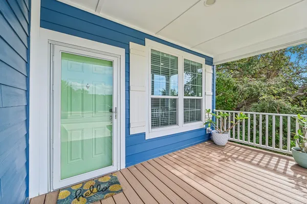 a view of a room with wooden floor and windows