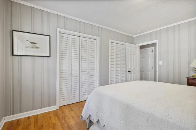 a bedroom with a bed and a wall painting