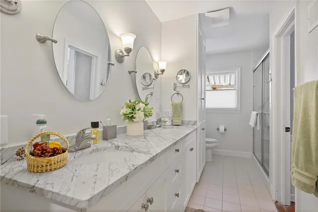 a bathroom with a granite countertop sink mirror and vanity