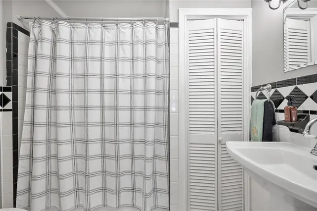 a bathroom with a sink and a shower curtain