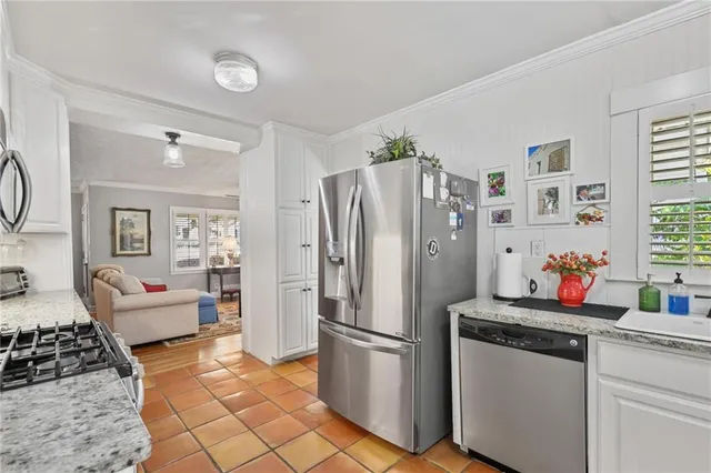 a kitchen with a refrigerator and furniture