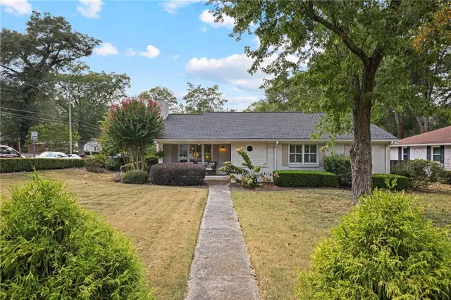 a front view of a house with a yard table and chairs