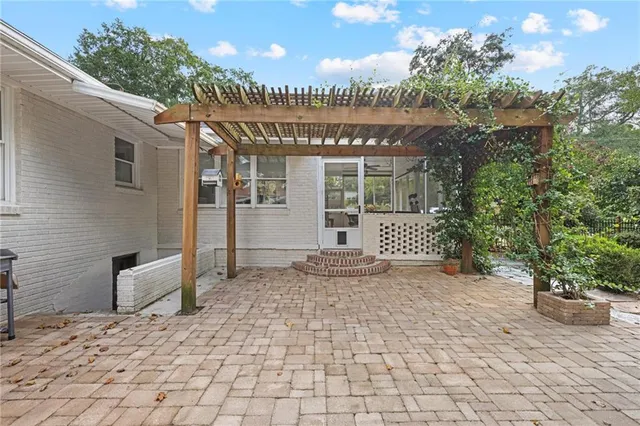 a view of a house with a patio and a garden