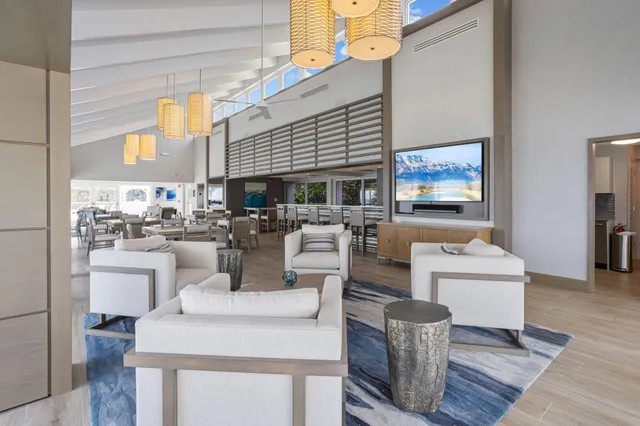 a living room with fireplace furniture and a large window