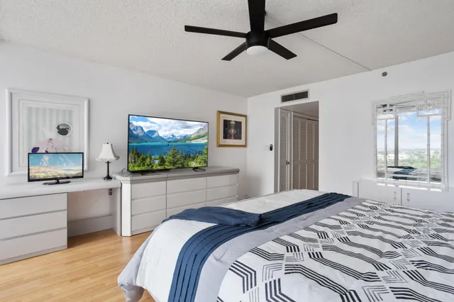 a bathroom with a granite countertop sink mirror vanity and toilet